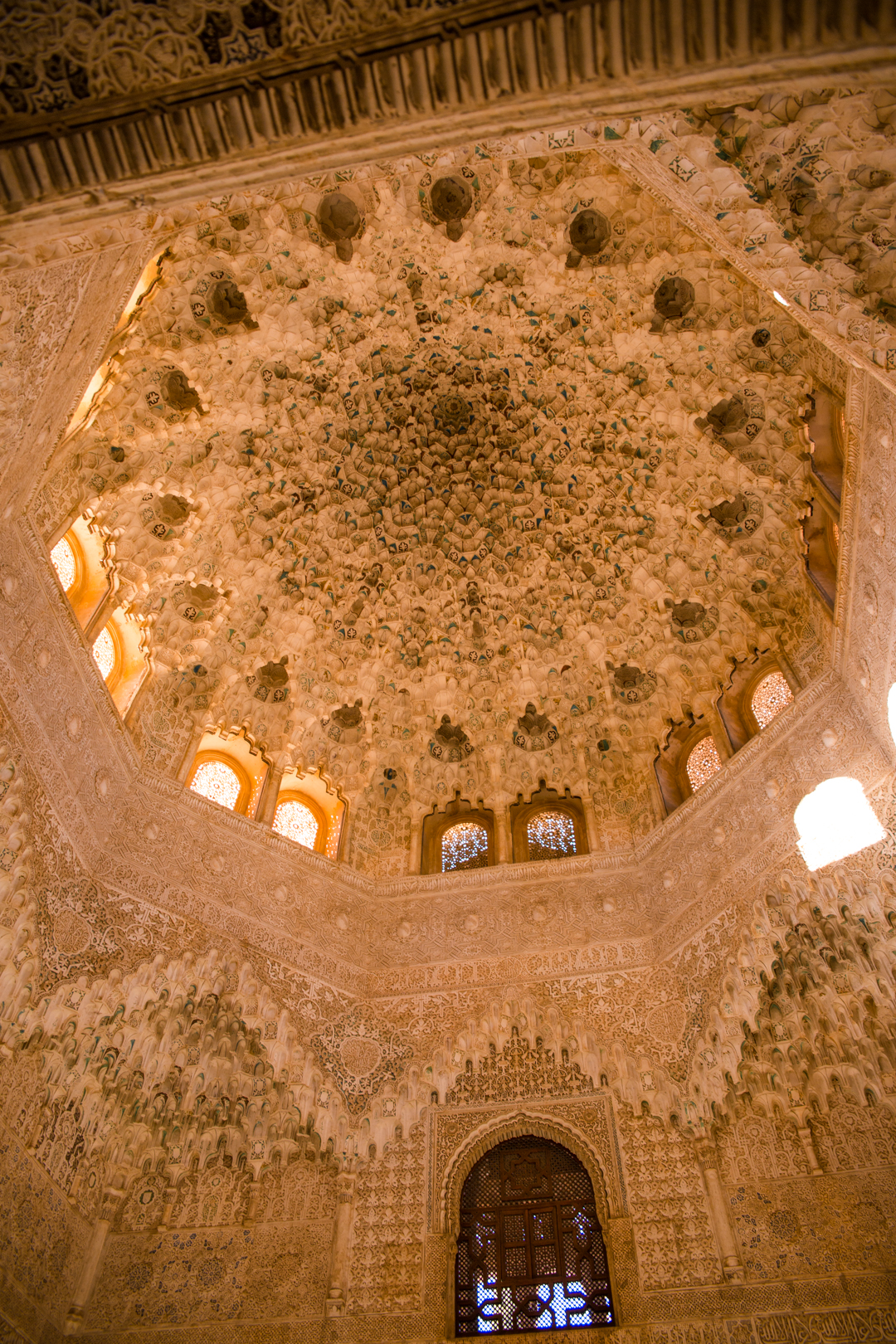 The intricate decorations and engravings in the ceiling at the Hall of Ambassadors inside the Alhambra, Granada, Spain.