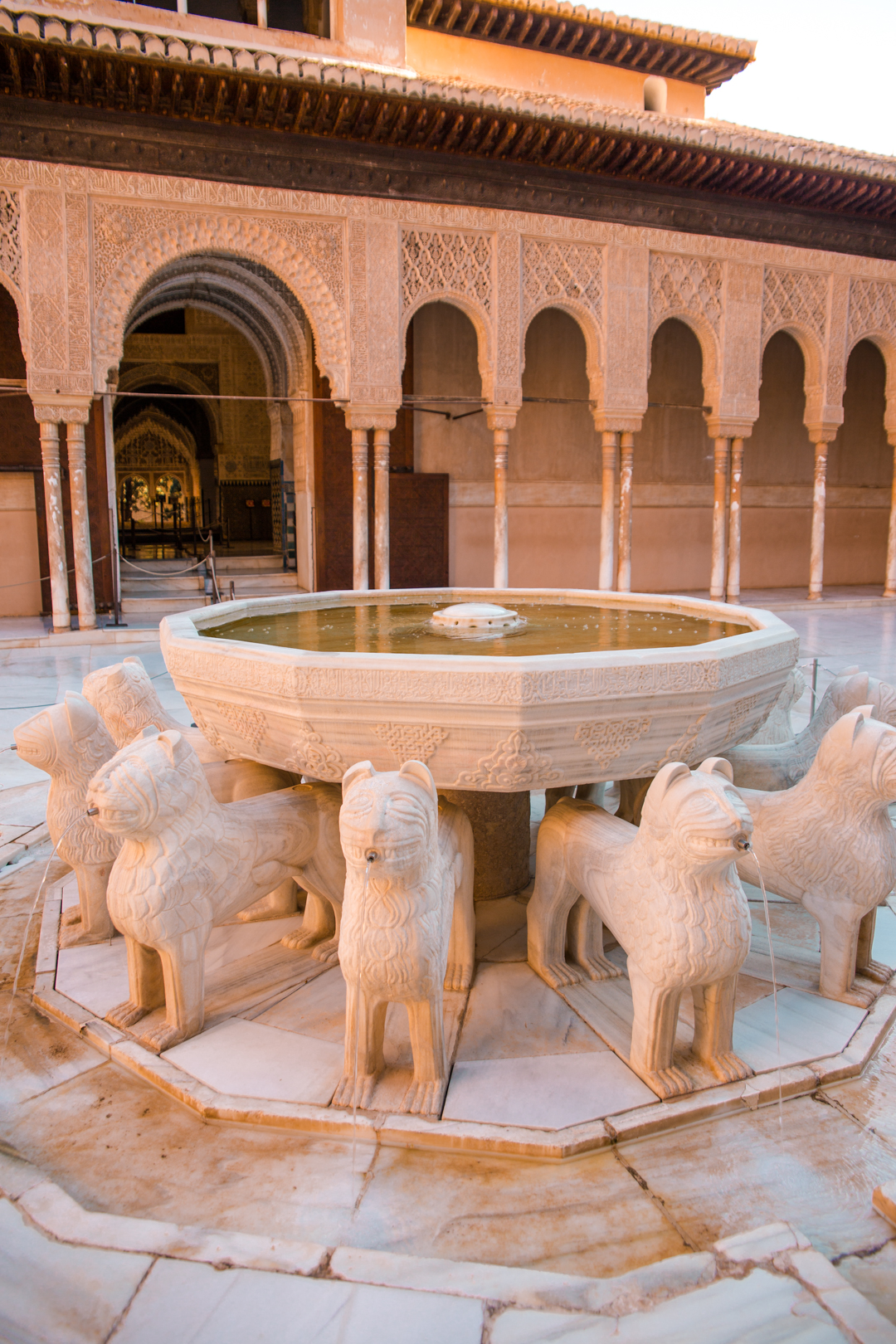 Detailed photo of the Patio de los Leones fountain in Alhambra, Granada.
