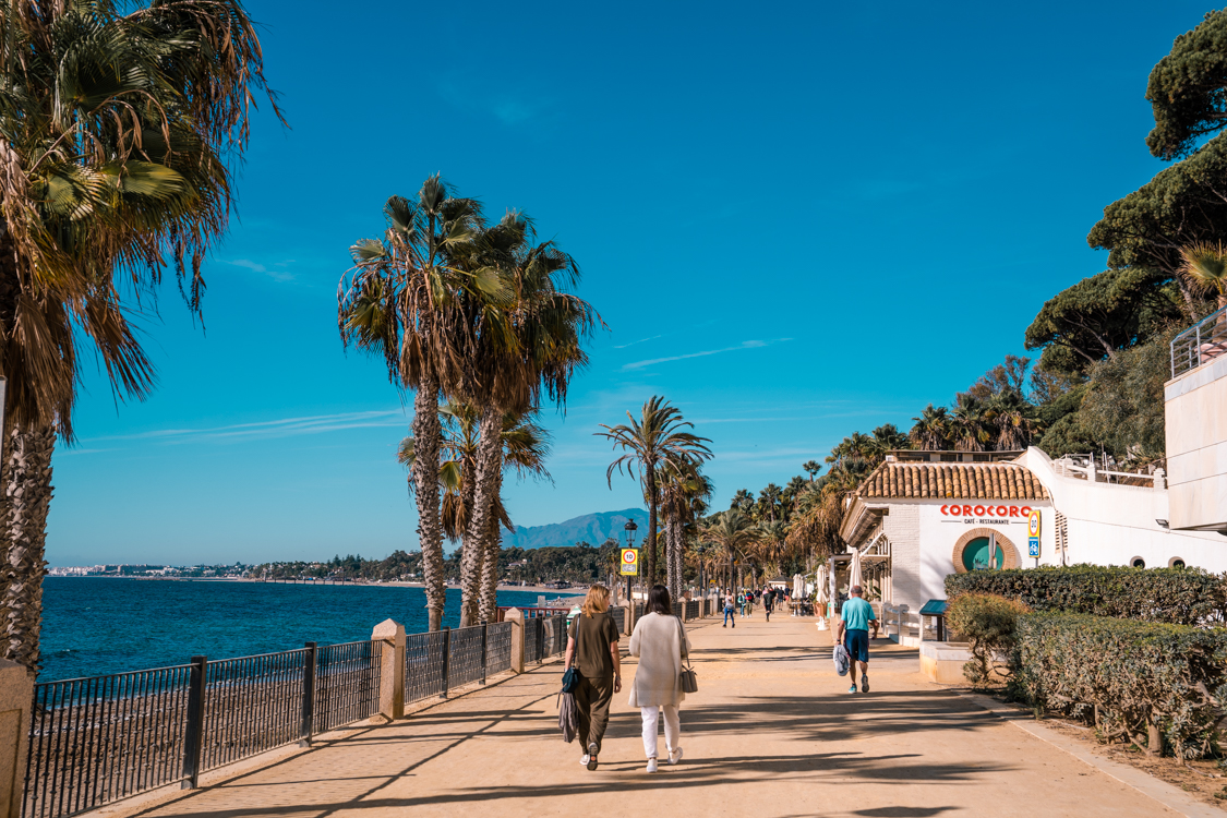 People walking on the coastal promenade in Marbella, Costa del Sol in Southern Spain.