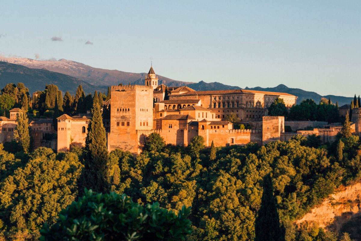 The building of Alhambra in sunset light as seen from Mirador San Nicolas, in Granada, Spain