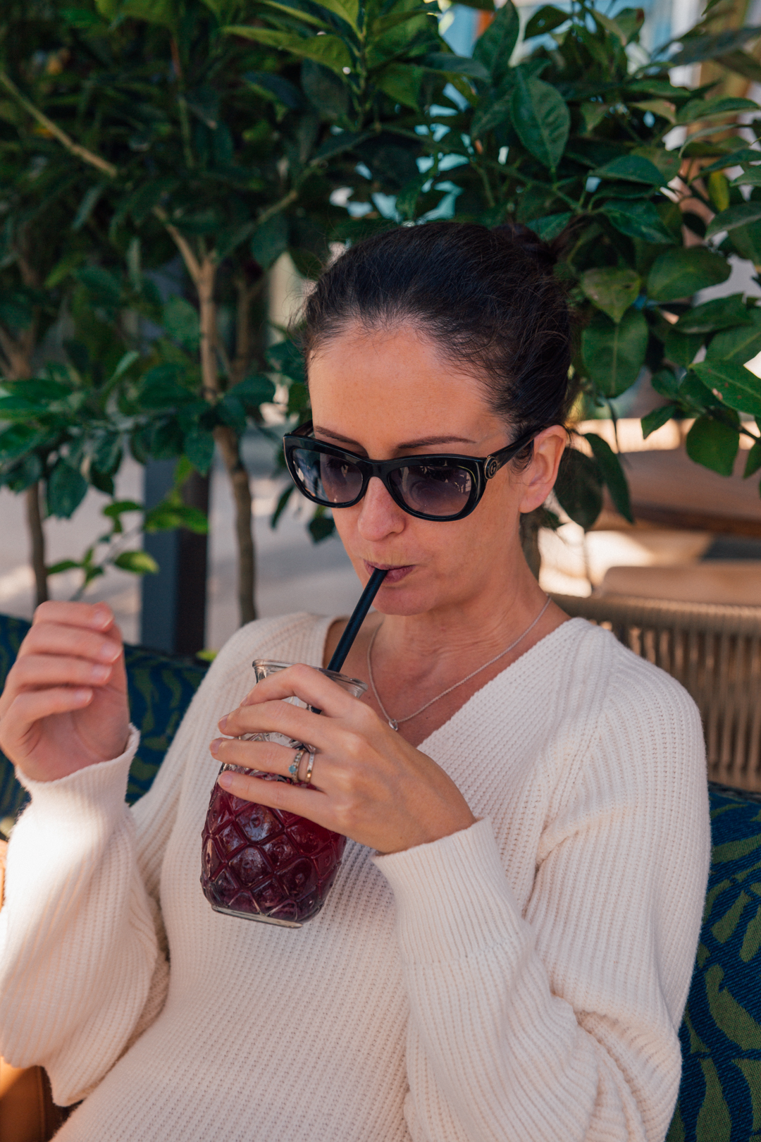 a woman having a smoothie in a restaurant in Marbella, Spain